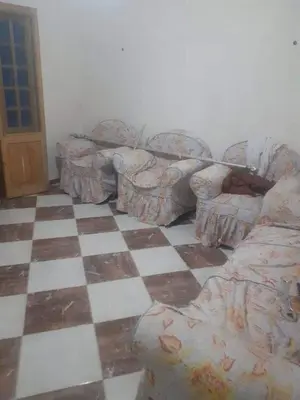 a living room with a couch and a checkered floor at 3030 Inn in Irbid