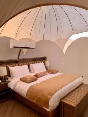 a bedroom with a large bed in a dome at Msek wadi rum camp in Disah