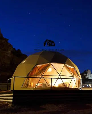 a large dome tent is lit up at night at ROYAL MOON BUBBLES lUXURY CAMP in Wadi Rum