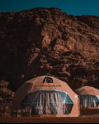 two domes in front of a rocky mountain at ROYAL MOON BUBBLES lUXURY CAMP in Wadi Rum