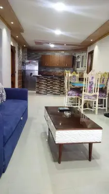 a living room with a blue couch and chairs at Rest Inn in Kerak