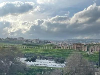 a view of a city under a cloudy sky at زهرة المدائن in Jerash