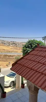 a roof of a building with a car in a parking lot at زهرة المدائن in Jerash