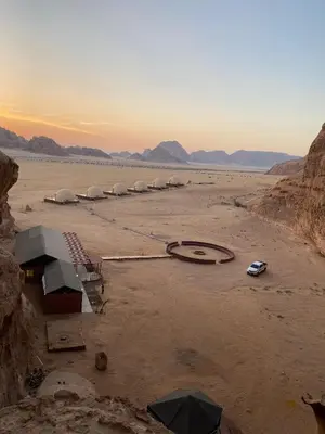 a group of domes in the middle of a desert at Wadi Rum Neom camp in Wadi Rum