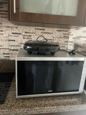a suitcase sitting on top of a microwave at The F52 Luxury Residence Samarah Resort in Sowayma
