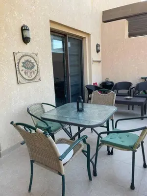 a table and chairs sitting on a patio at The F52 Luxury Residence Samarah Resort in Sowayma