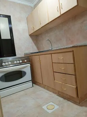 a kitchen with a stove and a sink and a dishwasher at Kamalia Studio in Şāfūţ