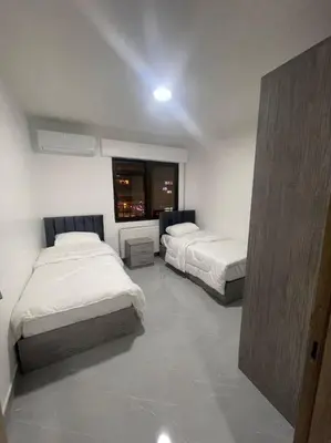 a bedroom with two beds and a window at شقارى 12 in Ţāb Kirā‘