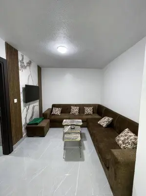 a living room with a couch and a table at شقارى 16 in Ţāb Kirā‘