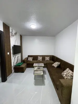 a living room with a couch and a table at شقارى 8 in Ţāb Kirā‘