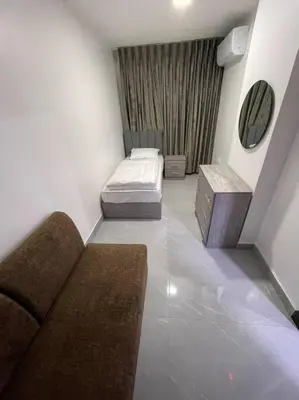 a small room with two beds and a mirror at شقارى 8 in Ţāb Kirā‘