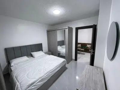 a bedroom with a large bed and a mirror at شقارى 8 in Ţāb Kirā‘