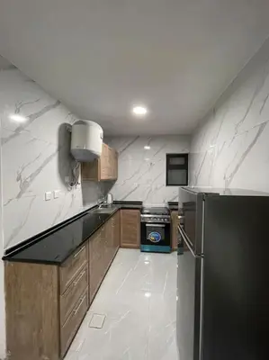 a kitchen with a black and white counter top at شقارى 5 in Ţāb Kirā‘