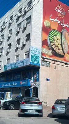 a building with cars parked in front of it at شقارى 9 in Ţāb Kirā‘