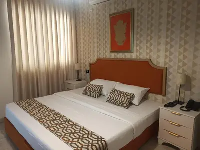 a bedroom with a large bed with two pillows at New Rafi Hotel in Amman