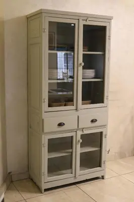 a white cabinet with glass doors in a room at New Rafi Hotel in Amman