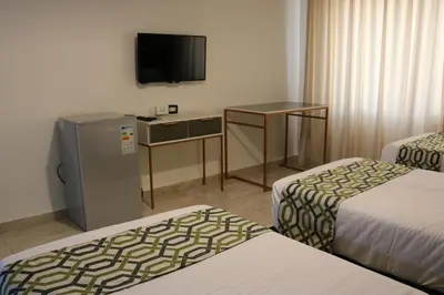 a hotel room with two beds and a television at New Rafi Hotel in Amman