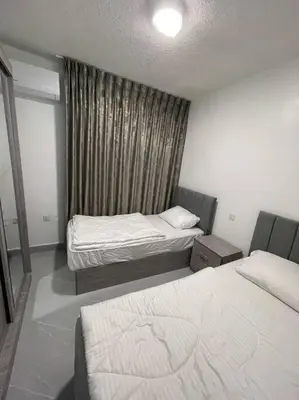 a small room with two beds and a window at شقارى 15 in Ţāb Kirā‘