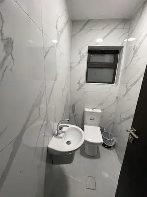 a white bathroom with a sink and a toilet at شقارى 6 in Ţāb Kirā‘
