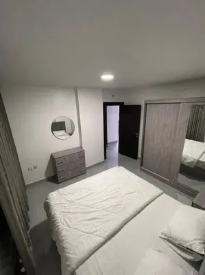 a bedroom with a large bed in a room at شقارى 7 in Ţāb Kirā‘