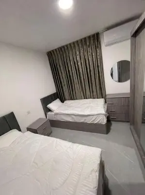 a hotel room with two beds and a window at شقارى 10 in Ţāb Kirā‘