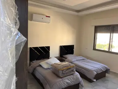 two beds in a room with two beds sidx sidx sidx at شقة مفروشة و جديدة مع كراج للسيارة في ارقى مناطق اربد in Irbid