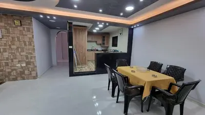 a dining room with a table and black chairs at City centre Apartment in Petra
