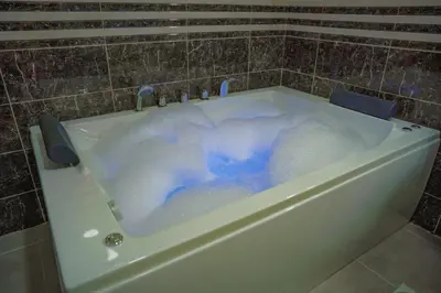 a bath tub filled with lots of bubbles at Tallet falastin in Umm Juraysāt