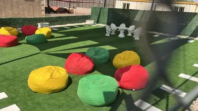 a group of colored balls on the grass at Tallet falastin in Umm Juraysāt