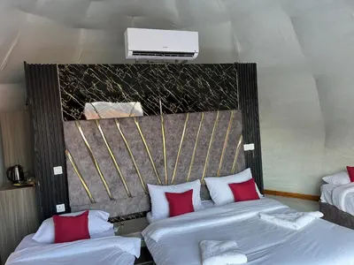 a hotel room with two beds with red pillows at Rum Rosella camp in Wadi Rum