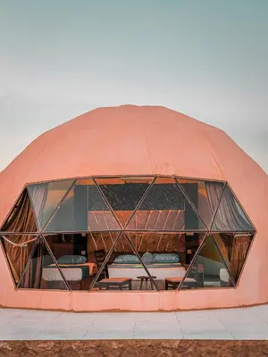 a large dome building with windows on the side at Rum Rosella camp in Wadi Rum