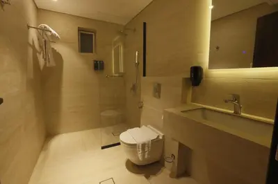 a bathroom with a toilet and a sink at G Hotel Amman in Amman