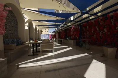 a hallway with tables and chairs in a building at G Hotel Amman in Amman