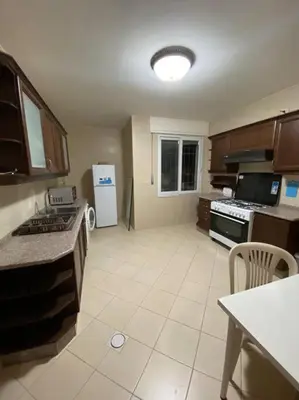 a kitchen with a stove and a refrigerator at Apartment in Amman Khalda in Amman