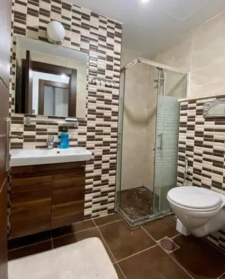 a bathroom with a toilet and a sink and a shower at Apartment in Amman Abdoun area in Amman
