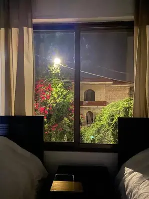 a window in a bedroom with a view of a garden at Apartment in Amman Abdoun area in Amman