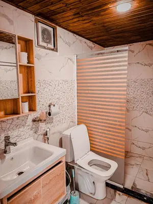 a bathroom with a toilet and a sink at RUM YANAL lUXURY CAMP in Wadi Rum
