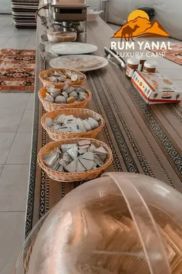 a buffet with baskets of food on a table at RUM YANAL lUXURY CAMP in Wadi Rum