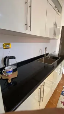 a kitchen counter with a sink and a cup on it at SeaStar Sea View apartment 10 minutes away from beach in Sowayma