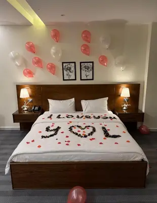 a bedroom with a bed with hearts and balloons at North paradise hotel in Irbid