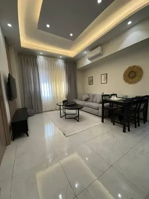 a living room with a couch and a table at Nozoll Boutique Residences in Amman