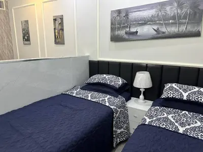 two beds sitting next to each other in a bedroom at استوديو مفروش لشخصين الجاردنز 320 in Amman