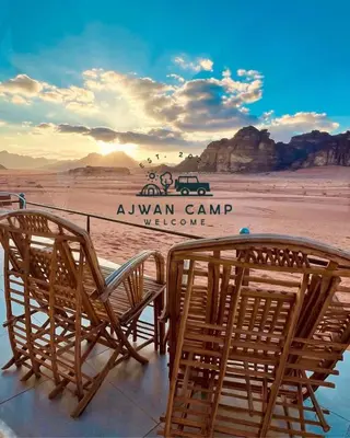 a group of chairs sitting on top of a beach at WADI RUM AJWAN lUXURY CAMP in Wadi Rum