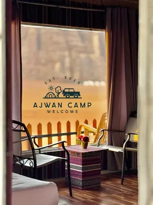 a window with a sign that says awan camp welcome at WADI RUM AJWAN lUXURY CAMP in Wadi Rum
