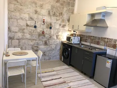 a kitchen with a table and a counter top at Cozy Apt in amman with a view in Amman