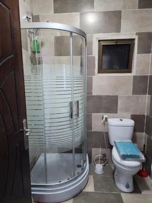 a bathroom with a shower and a toilet at Salo StudioS in Amman