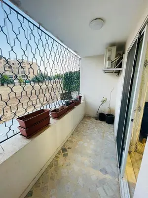 a hallway with a tile floor and a wall with a window at Cozy 2 bedroom apartment in Amman