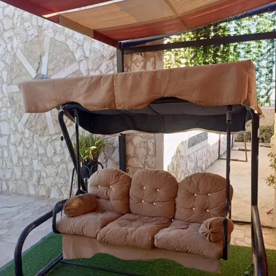 a couch under a canopy in a patio at luxury house in Madaba