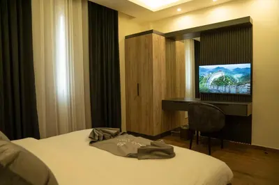 a hotel room with a bed and a flat screen tv at Sea Gate Resort in Sowayma