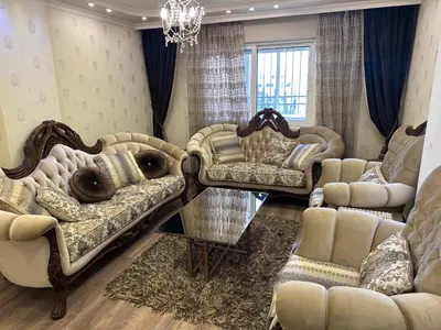 a living room with two couches and a chandelier at شقه في اربد apartment in irbid in Irbid